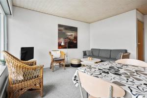 a living room with a table and a couch at 0265-Romo-Lyngvejen-99-Ap-18 in Høm +10 photos