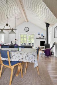 a dining table and chairs in a living room at 0130-Romo-Ejnar-Mikkelsensvej-22 in Høm