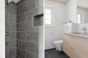 a bathroom with a shower and a toilet and a sink at 0130-Romo-Ejnar-Mikkelsensvej-22 in Høm +28 photos