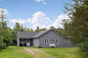 a gray house with a yard in front of it at 0130-Romo-Ejnar-Mikkelsensvej-22 in Høm