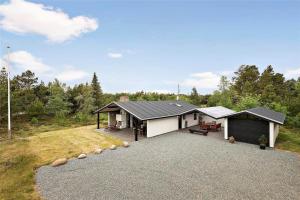 a house with a garage and a driveway at 0321-Romo-Stormengevej-4 in Høm