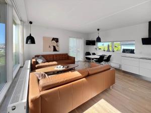 a living room with a brown couch and a table at 0277-Romo-Hollaenderstraedet-38 in Høm