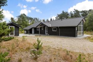 a home with a black house at 0308-Romo-Vagtelvej-4 in Høm