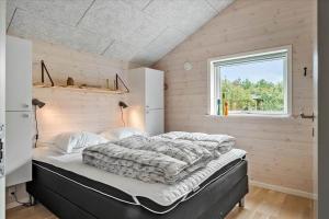 a large bed in a room with a window at 0308-Romo-Vagtelvej-4 in Høm