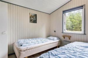 a bedroom with two beds and a window at 0240-Romo-Peder-Jespersensvej-9 in Høm