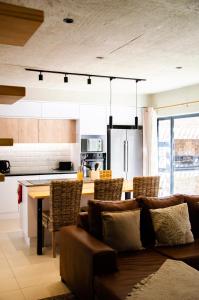 a kitchen with a couch and a table with chairs at Rustic Hills No 3 Self Catering in Swakopmund