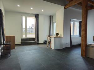 a large room with a desk and a table with a desk at Roomies Luxembourg Centre Gare in Luxembourg