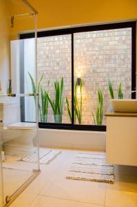 a bathroom with a window with plants in it at Rustic Hills No 3 Self Catering in Swakopmund