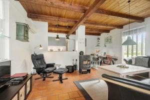 a living room with leather chairs and a fireplace at 0162-Romo-Rabjergvej-97 in Høm