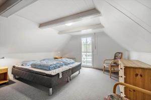 a bedroom with a bed and a desk and a window at 0162-Romo-Rabjergvej-97 in Høm