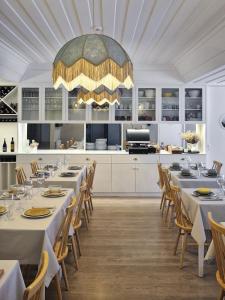 a dining room with tables and chairs and a large chandelier at Retiro do Gerês in Geres