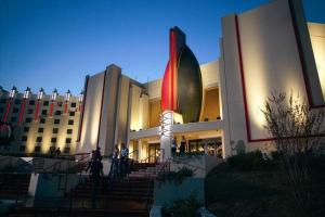 a large building with a flag in front of it at SpringHill Suites by Marriott Tulsa in Union
