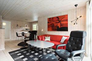 a living room with a red couch and a table at 0424-Romo-Sonderstrandvej-15 in Høm