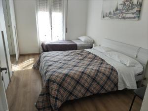 a bedroom with two beds in a room at Brunate Funicolare Apartament in Brunate