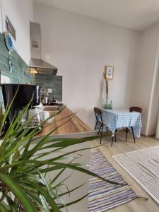 a living room with a table and a kitchen at SEA VIEW in Nea Skioni
