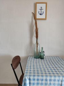 a table with a blue and white checkered table cloth and a vase at SEA VIEW in Nea Skioni