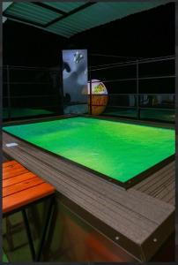a green ping pong table with a ball on it at Elsy Villa Negombo in Negombo