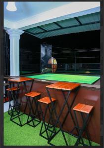 a bar with three stools and a basketball court at Elsy Villa Negombo in Negombo