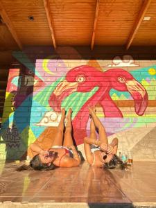 two girls laying on the floor in front of a mural at Vientos San Pedro in San Pedro de Atacama