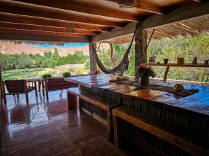 a large wooden table in a room with a view at Vientos San Pedro in San Pedro de Atacama