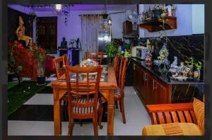 a kitchen with a wooden table and chairs at Elsy Villa Negombo in Negombo