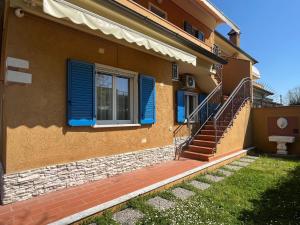 a house with blue shutters and stairs on it at Sunflower Guest House in Carrara +26 photos