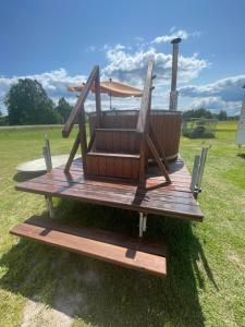 a wooden deck with a chair on top of it at FarmaKolonia2 in Zabiele