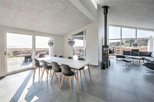a dining room with a table and chairs at 0226-Romo-A-M-Listsvej-4 in Høm