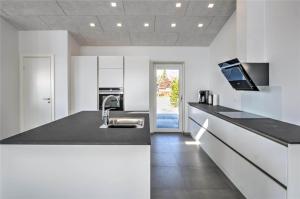 a white kitchen with a sink and a counter top at 0226-Romo-A-M-Listsvej-4 in Høm