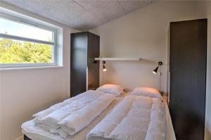 a bedroom with two beds and a window at 0226-Romo-A-M-Listsvej-4 in Høm