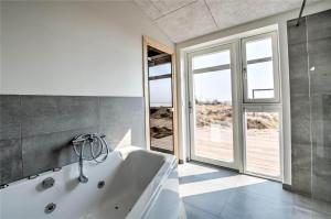 a white bath tub in a room with windows at 0226-Romo-A-M-Listsvej-4 in Høm +41 photos