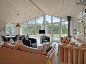 a living room with couches and chairs and a table at 0195-Romo-Smafolksvej-65 in Høm