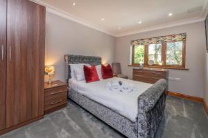 a bedroom with a large bed with red pillows on it at Hamble House in Southampton +47 photos