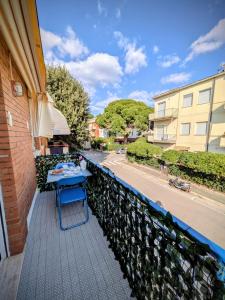 a table on the balcony of a building at In Via Capri 1991 APARTMENT in Follonica