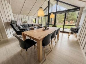 a living room with a wooden table and chairs at 0340-Romo-Dvaergternen-2 in Høm