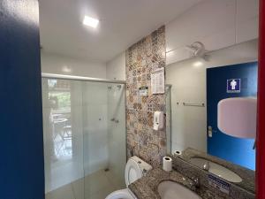 a bathroom with a toilet and a sink and a shower at Pousada Vila Catarina in Ouro Preto