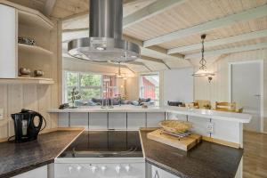 a kitchen with a sink and a stove top oven at 0223-Romo-Sonderstrandvej-12 in Høm +19 photos