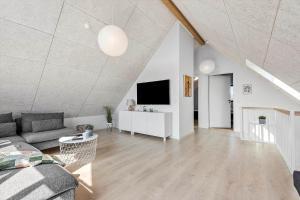 a living room with a couch and a tv at 0433-Romo-Vestergade-345 in Høm