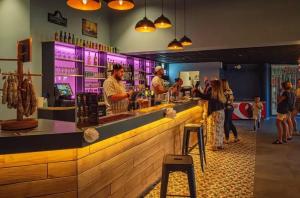 a group of people standing at a bar at ZEcamping animations espace aquatique piscine couverte et restaurant in Saint-Hilaire-de-Riez