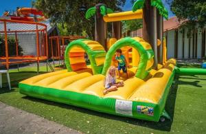 two children playing on a inflatable play structure in a park at ZEcamping animations espace aquatique piscine couverte et restaurant in Saint-Hilaire-de-Riez