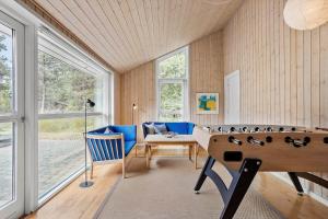 a room with a pool table and a couch and windows at 0317-Romo-Sonderstrandvej-24 in Høm