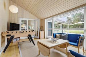 a living room with a pool table and a couch at 0317-Romo-Sonderstrandvej-24 in Høm