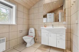 a bathroom with a toilet and a sink at 0317-Romo-Sonderstrandvej-24 in Høm +30 photos