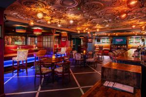 a restaurant with tables and chairs and a bar at The Marcy Hotel in Drogheda
