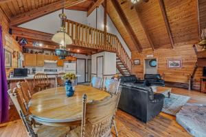 a dining room and living room with a wooden ceiling at Lazy Bear Retreat - Wifi, Pet Friendly, Grill, Fire Pit, Fireplace, Deck, Golf, Hiking in Morton Grove