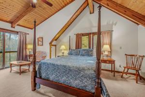 a bedroom with a bed and chairs in a room at Lazy Bear Retreat - Wifi, Pet Friendly, Grill, Fire Pit, Fireplace, Deck, Golf, Hiking in Morton Grove