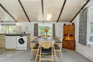 a kitchen and dining room with a table and chairs at 0312-Romo-Vagtelvej-8 in Høm +23 photos