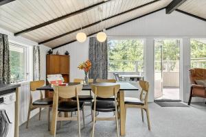 a kitchen and dining room with a table and chairs at 0312-Romo-Vagtelvej-8 in Høm