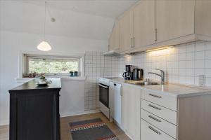 a kitchen with a sink and a counter top at 0309-Romo-Stagebjergvej-13 in Høm +13 photos