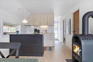 a kitchen with a stove in the middle of a room at 0309-Romo-Stagebjergvej-13 in Høm